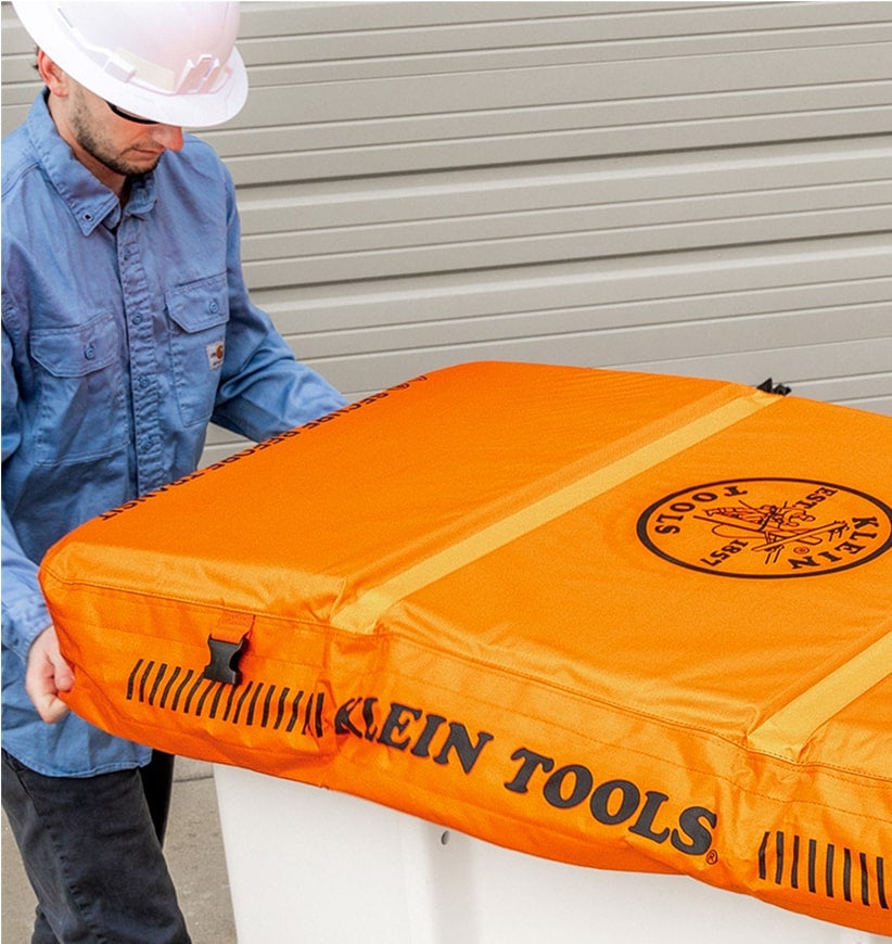 man installing a bucket cover on a lineman bucket