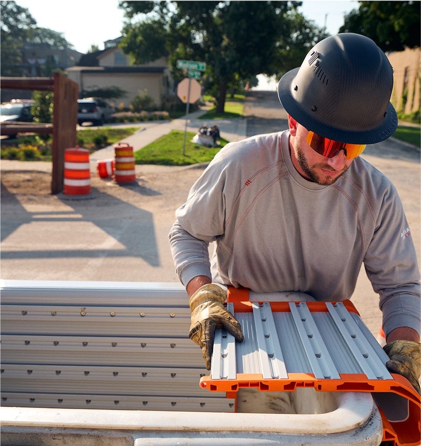 man installing a rail system module on a lineman bucket
