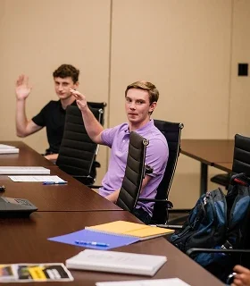 Klein Tools interns sitting at table in a meeting