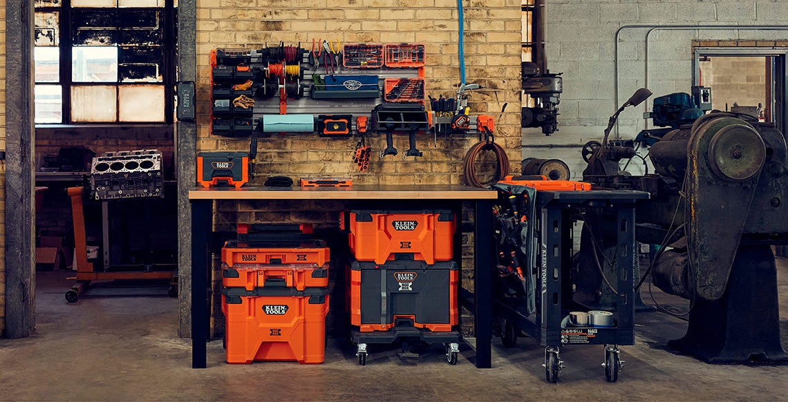 photo of modwall system setup in autobody shop on brick wall with modbox accessories attached and Klein Tools products placed in accessories