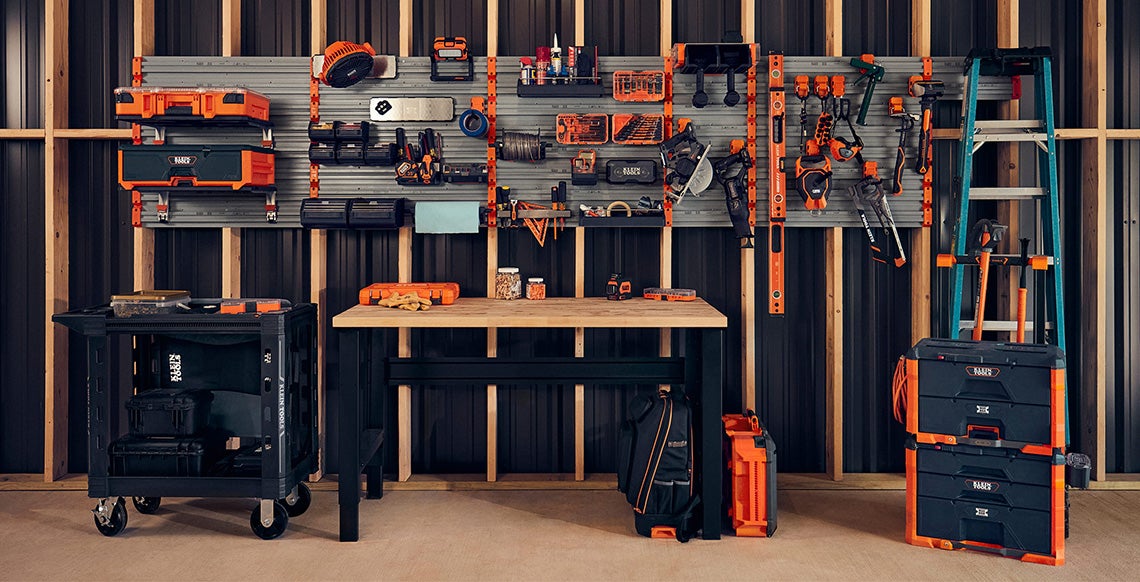 photo of modwall system setup in unfinished work room with modbox accessories attached and Klein Tools products placed in accessories