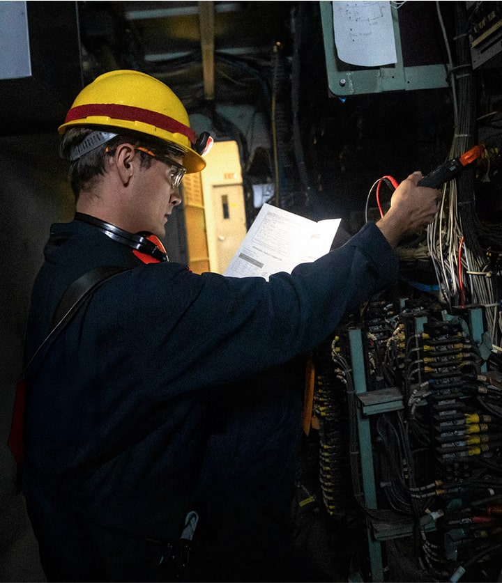 electrician working on circuit breaker box