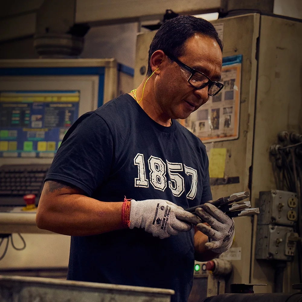 Klein Tools US forging plant worker quality inspecting a pair of pliers