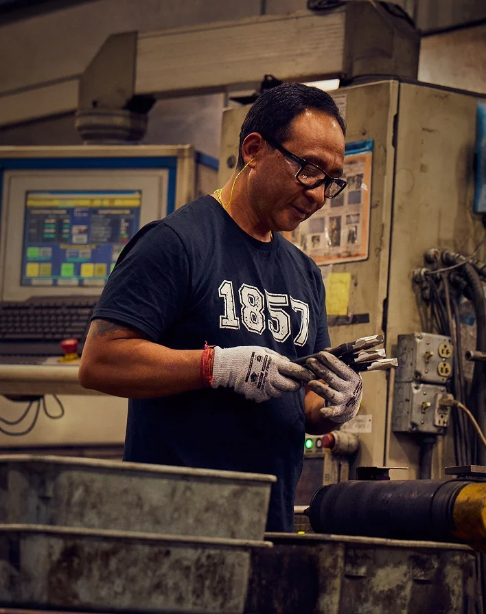 Klein Tools US forging plant worker quality inspecting a pair of pliers