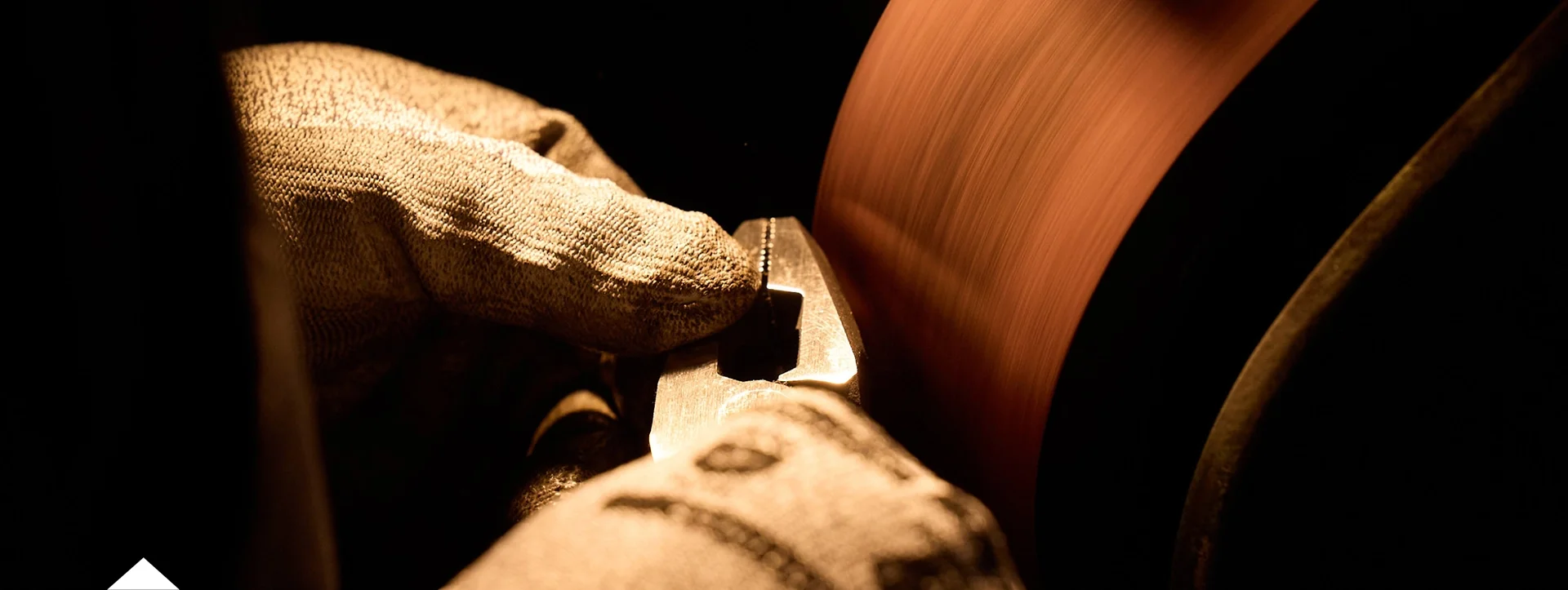 photo of worker grinding pliers