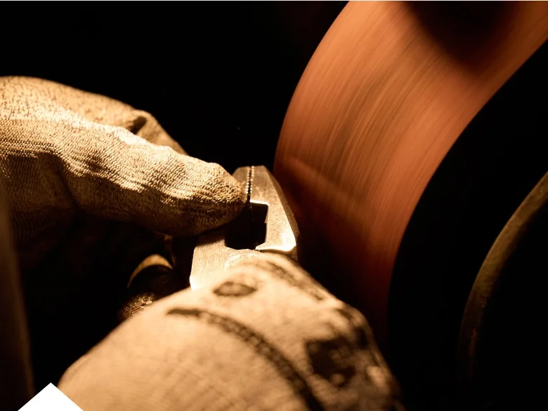 photo of worker grinding pliers