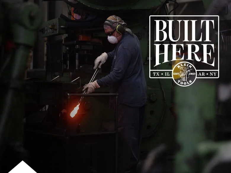 photo of worker holding a pair of pliers in a forge