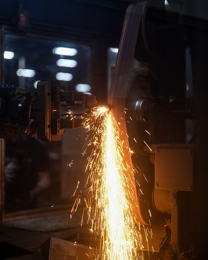 Klein Tools US forging plant worker grinding tools with sparks flying
