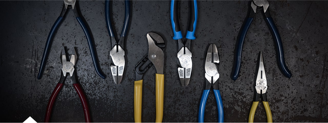 photo of USA made pliers laying on table with bin of pliers next to it