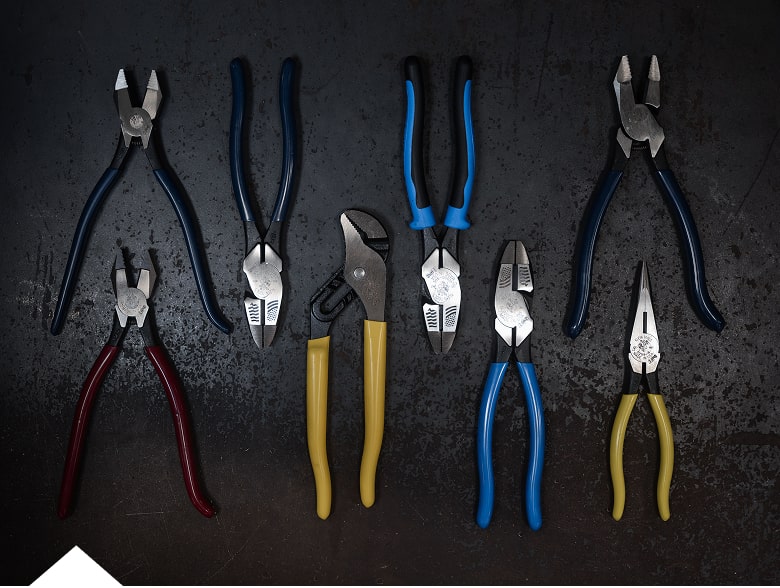 photo of USA made pliers laying on table with bin of pliers next to it